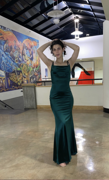 Carolina Osoria posing in a green dress