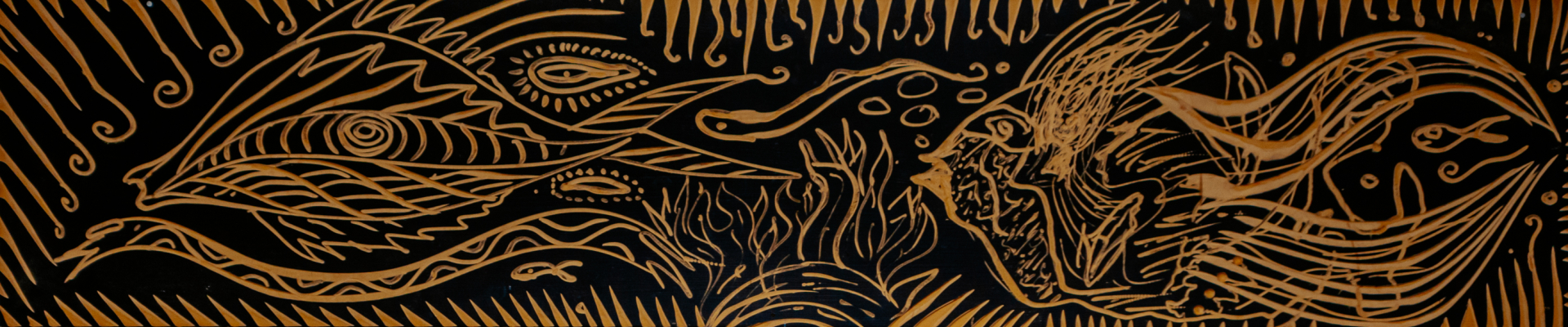 A wood carving depicting fish by Tonu Shane Eagleton