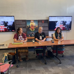 Three Native American women giving a talk