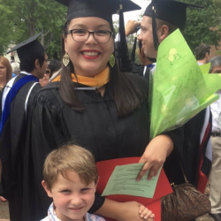 Jessica Orozco wearing cap and gown standing with her nephew James Kitchens